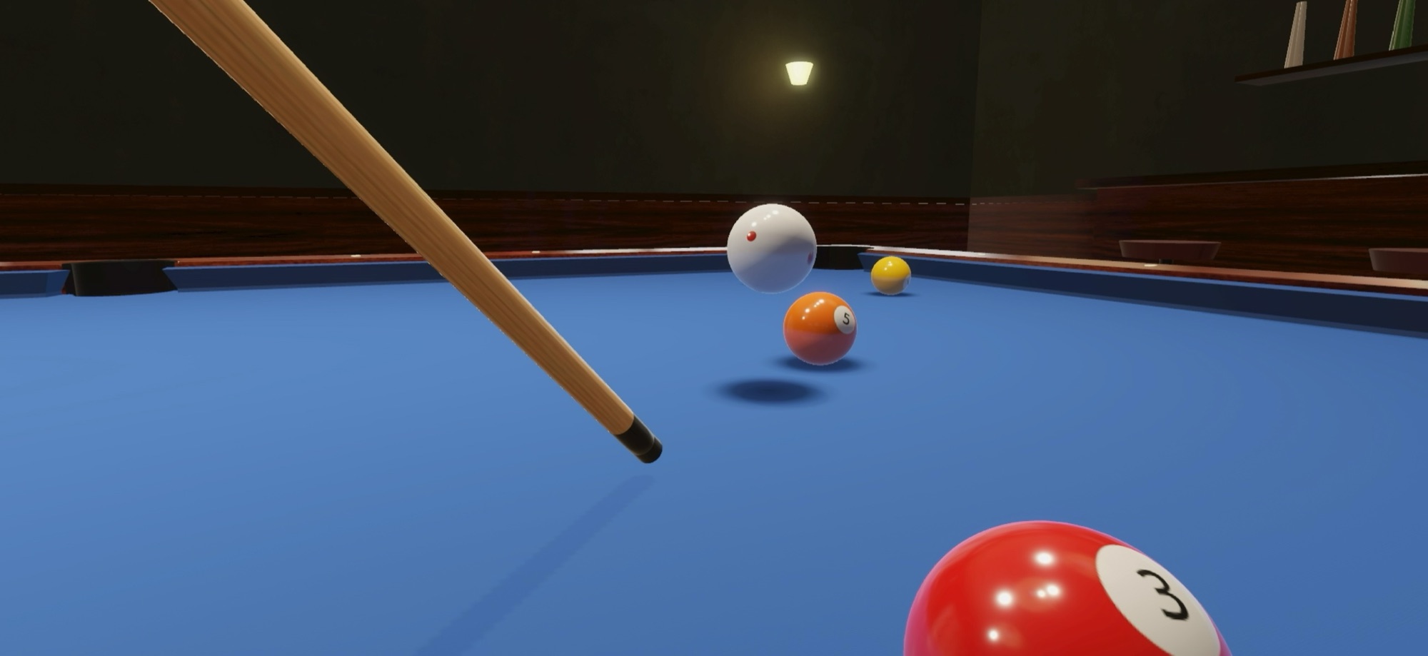 A jump shot: the cue ball in the air over the 5-ball, its shadow on the cloth below.